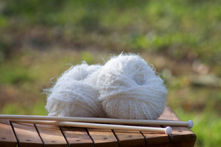 white balls of woll on a wooden chairの写真素材