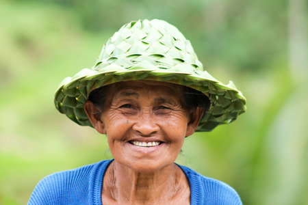 BALI, INDONESIA - September 11, 2013 portrait of balinese woman selling hats in bamboo near rice terraces in Ubudのeditorial素材