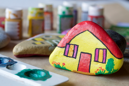 homemade painted stones as homes, blurred backgroundの写真素材