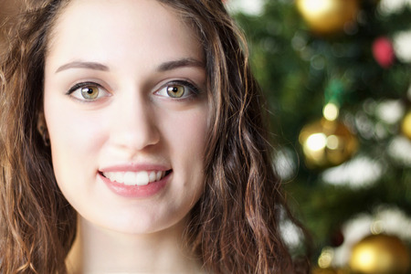 close up portrait of a beautiful happy girl on Christmas holidaysの写真素材