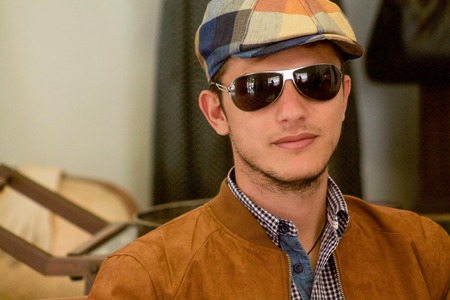 beautiful young man with sun glasses wearing vintage clothing