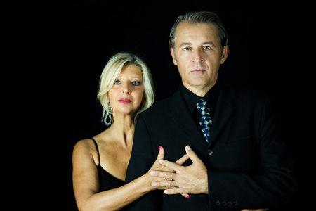 portrait of a passionate couple of professional tango dancers on black backgroundの写真素材