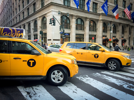 NEW YORK - OCTOBER 12, 2016: yellow cab speeds through fifth avenue intersection with east 35th street. Fifth avenue is an iconic street of New York City, USAのeditorial素材