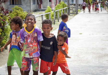 WEST PAPUA, RAJA AMPAT - August 28, 2017 :  group of unidentified asian indigenous children in a street of local village smiling and playing, Raja ampat archipelagoのeditorial素材