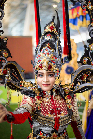 JAKARTA - September 5, 2018: portrait of beautiful woman in south east asia  traditional cerimonial costume  red , gray and black with precious stones during a paradeのeditorial素材