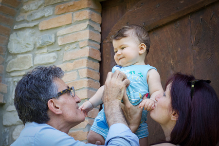 close portrait of grandparents interacting with grandson in the countryの写真素材