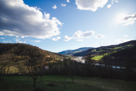 river flows at the bottom of the valley in emilia romagna hills, Italy