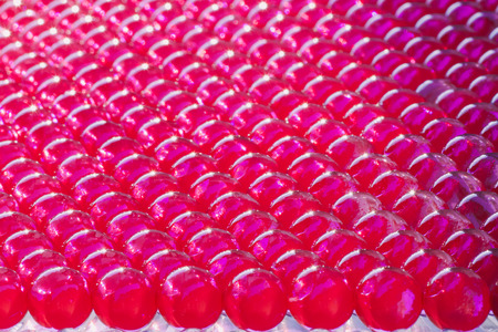 group of lined  shiny hydrogel balls in vivid fuchsia colorの写真素材