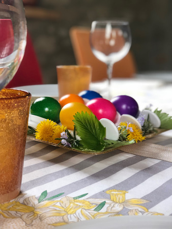 centerpiece for easter with multicolored hard-boiled chicken eggsの写真素材