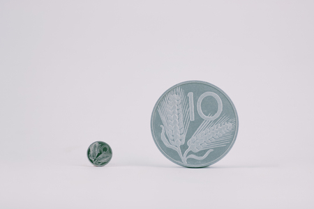 small and large coin of  ten old  italian lira on white background