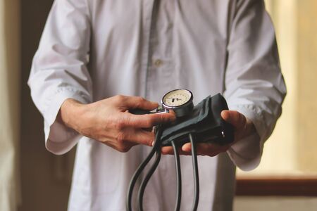 close up of  blood pressure measuring device in doctor hands