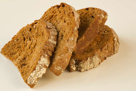 close up of dry rye bread slices isolated on white background