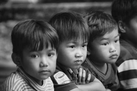 Rantepao, Sulawesi - August 23, 2014: group of unknown indonesian children sitting close together...
