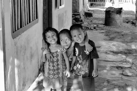 Togian islands, Indonesia - September 02, 2014: portrait of children of the village of sea gypsies Katupat, posing for tourists near house, Sulawesiのeditorial素材
