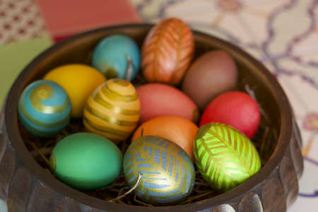 close up of easter centerpiece full of colored eggs, copy space