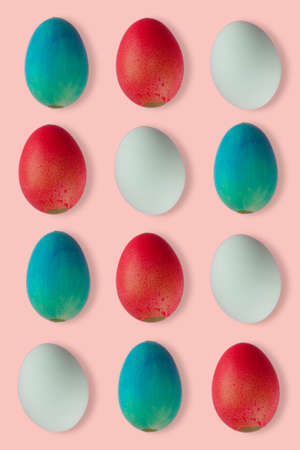 group of colored easter eggs on pink background, easter patternの写真素材