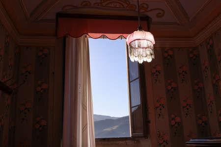 window open to blue sky in ancient residence on the hills, Italy