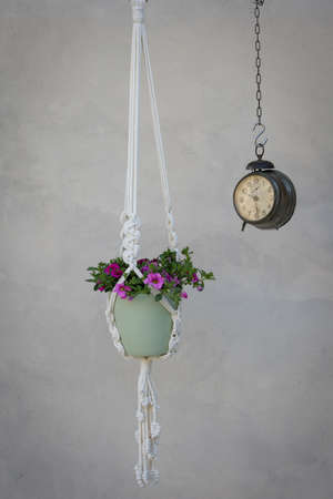 macrame plant hanger with flowers and old hanging wake up, home decor