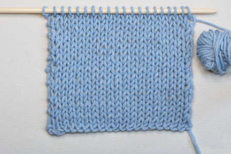 needlework in light blue yarn isolated on white background, view from above