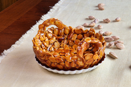 homemade almonds brittle in the shape of basket on a tableの写真素材