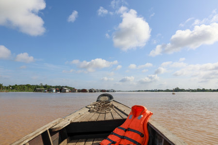 seascape with bow of wooden boat and life jacket on mekong river, Vietnamの写真素材