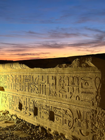 ancient carved wall with hieroglyphics outside Kom Ombo temple at sunset, Egyptの写真素材