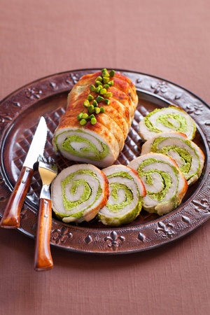 Roasted pork roulade with pistachio on plateの写真素材