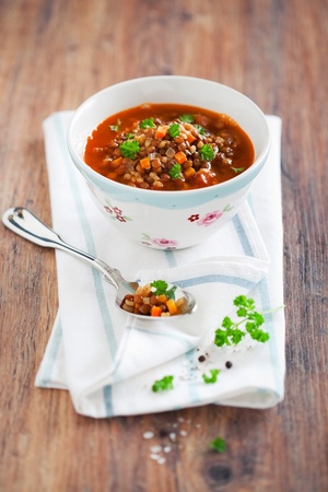 Brown lentil soup in a bowl on the table, selective focusの写真素材