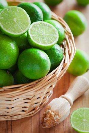 Fresh limes in basket, selective focus の写真素材
