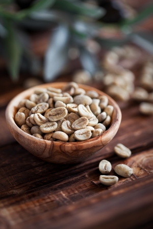 Green coffee beans in wooden bowl, selective focusの写真素材