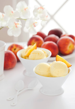 Homemade peach sorbet and fresh peaches, selective focusの写真素材