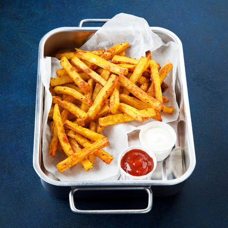 Spices curry fried potatoes in a metal baking dish, selective focusの写真素材