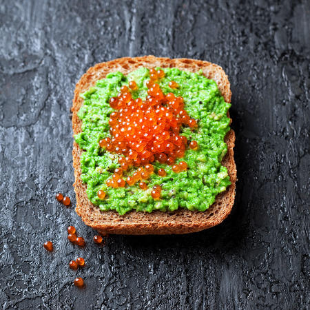 Avocado and red caviar sandwich, selective focusの写真素材