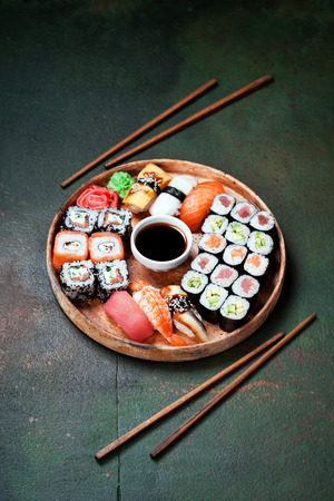 Sushi set nigiri and rolls served in round plate, selective focusの写真素材