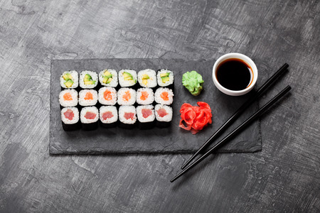 Sushi rolls served on stone slate, selective focusの写真素材