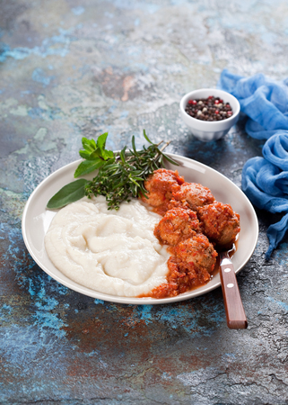 Meatballs with spicy tomato sauce and mashed cauliflower, selective focusの写真素材