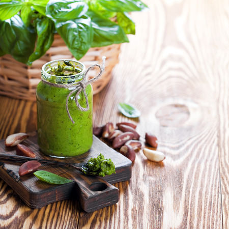 Homemade basil and cashew pesto in glass jar, selective focusの写真素材