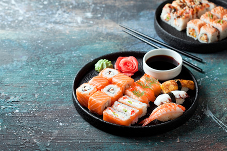 Sushi set nigiri and rolls served in round plate, selective focusの写真素材