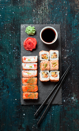 Sushi rolls served on stone slate, selective focusの写真素材