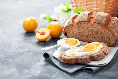 Homemade bread with yellow plum jam, selective focusの写真素材