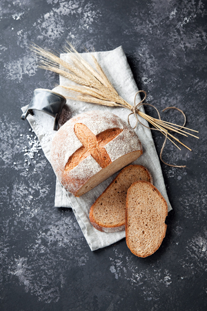 Homemade whole wheat bread on a grey background, selective focusの写真素材