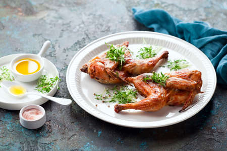 Halves grilled roast chicken and micro greens, selective focusの写真素材