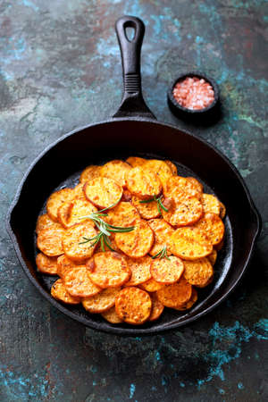 Roasted sweet potato in a cast iron pan, selective focusの写真素材