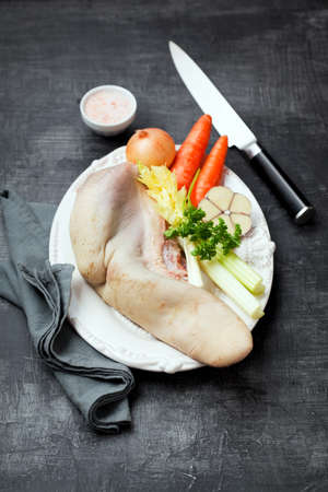 Raw beef tongue and fresh vegetables on a plate, selective focusの写真素材