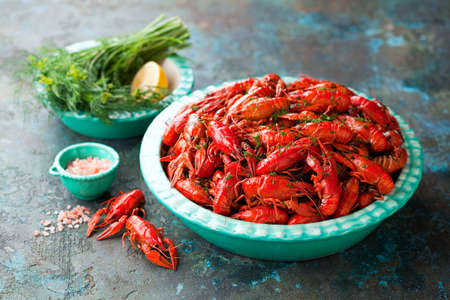 Boiled red crayfish with dill in a bowl on the table, selective focusの写真素材