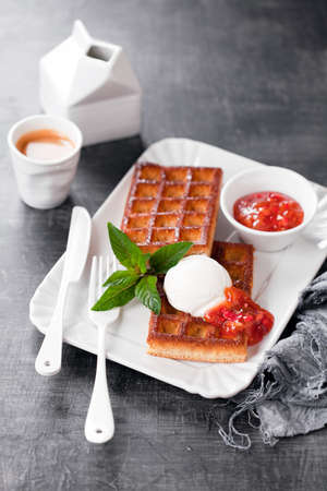 Homemade almond flour waffles with coconut ice cream and strawberry lemon jam, selective focusの写真素材