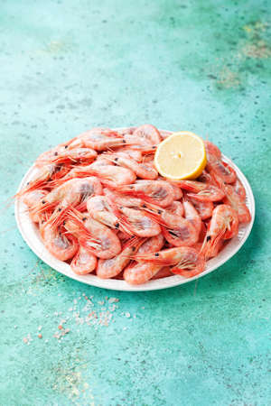 Boiled shrimps prawns with lemon on a plate, selective focusの写真素材