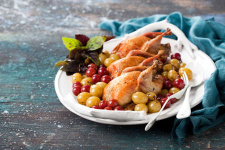 Roasted quails with baked grapes, selective focusの写真素材
