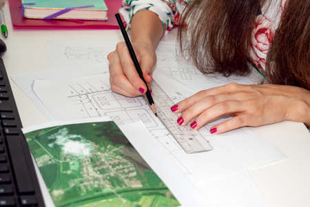 A nice business woman, architect, interior designer is working on the reconstruction and renovation ...