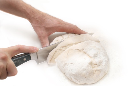 Hands in flour and cut the doughの写真素材